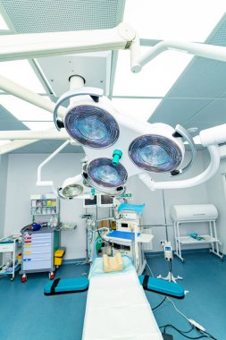 Blue cast light represent purity and clinical mood. Hospital modern surgery equipment.