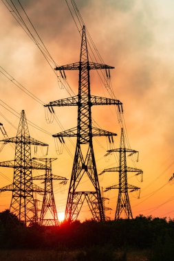 Electricity high voltage silhouette towers. Power energy distribution.