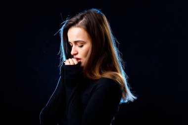 Young beautiful woman model. Portrait of pretty lady on dark background.