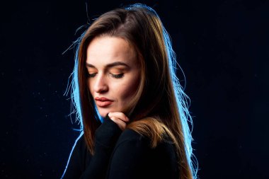 Portrait of pretty lady on dark background. Young beautiful woman model.