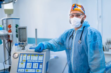 Male doctor in blue uniform and protective medical mask. Professional surgery specialist in medical uniform and mask.