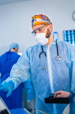 Operating specialist ready for work. Professional surgery man in mask and uniform.