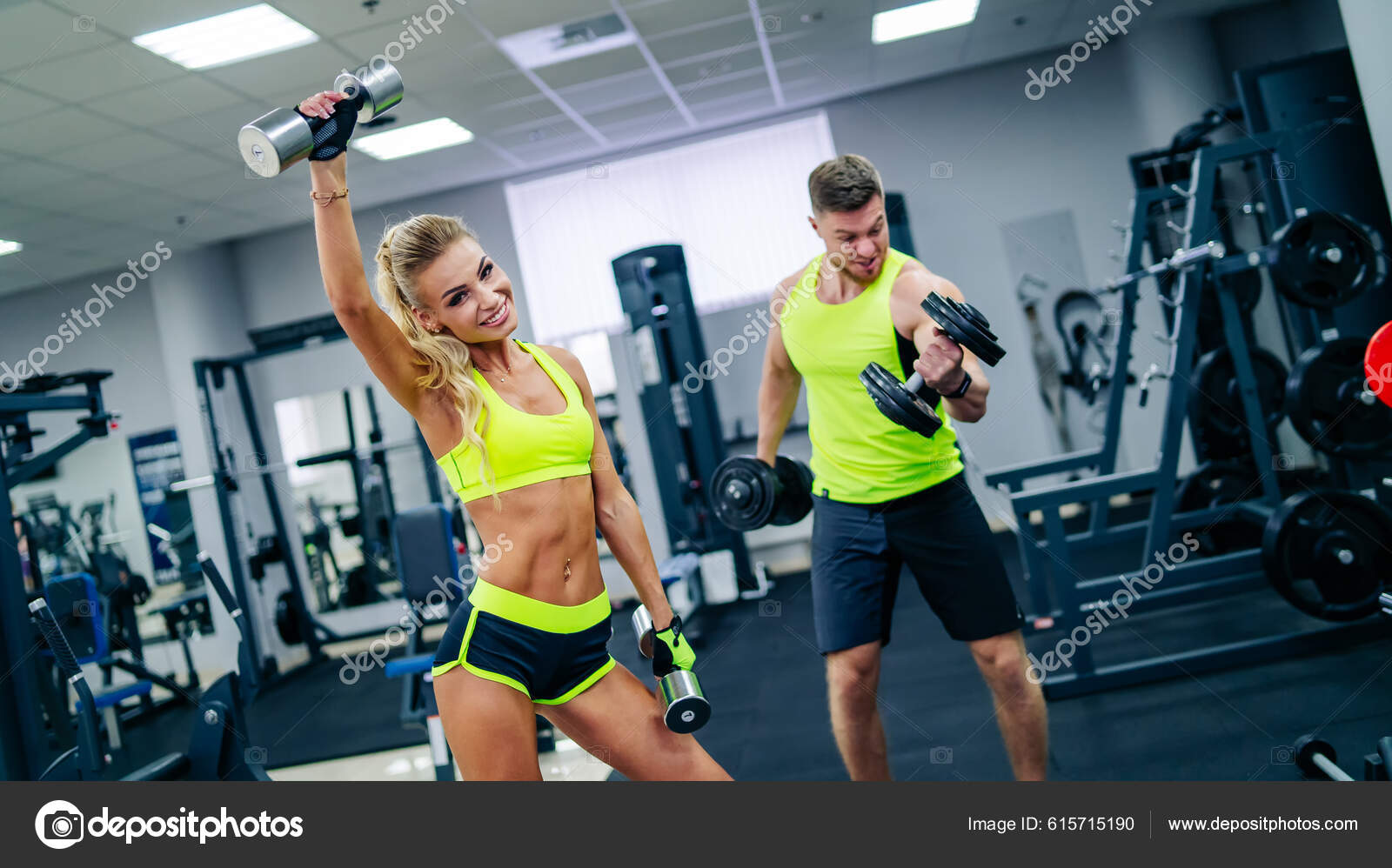 Perfect Fitness Body of Beautiful Woman. Fitness Instructor in Sports  Clothing. Female Model with Fit Muscular and Slim Body in Sportswear doing  Workout. Young Fit Girl Lifting Dumbbells. Stock Photo
