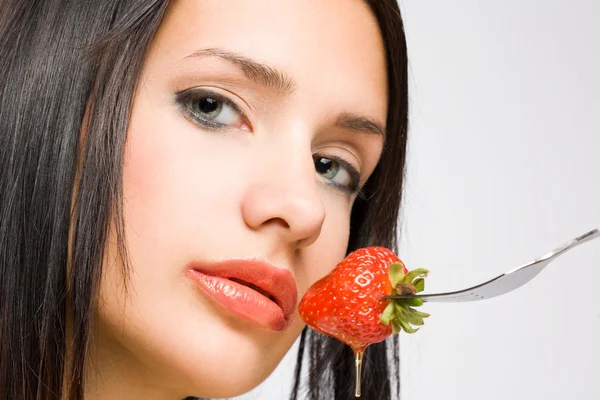 Gorgeous brunette with strawberry Stock Image