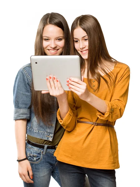 Teen girls sharing a tablet computer. Royalty Free Stock Images