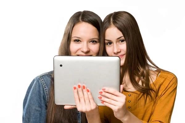 Teenagers having fun with a tablet computer. Royalty Free Stock Photos