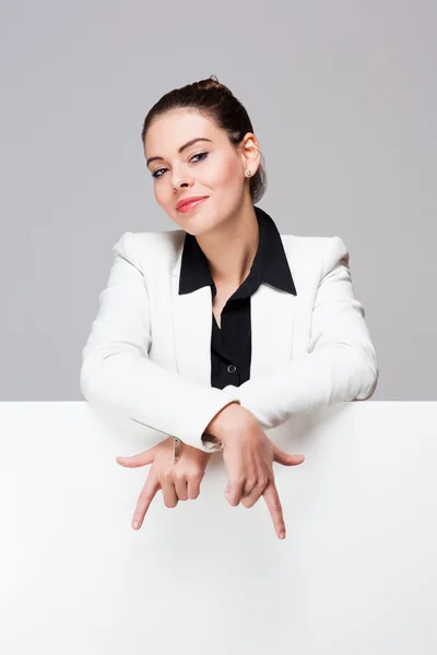 Young businesswoman with blank sign. — Stock Photo, Image