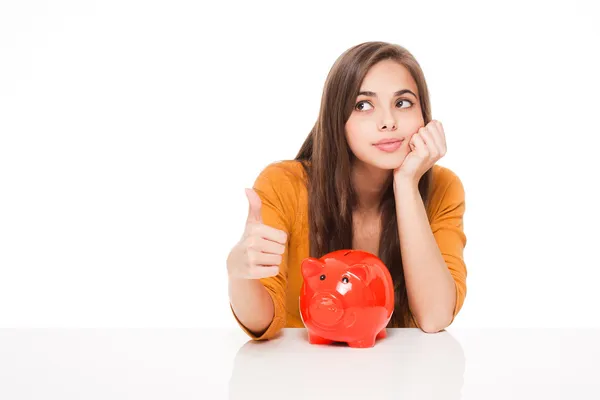 Brunette with piggy bank. — Stock Photo, Image