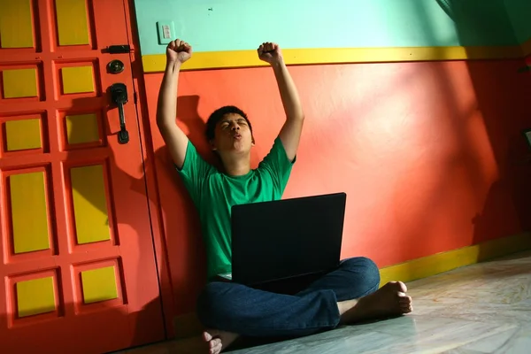 Young asian teen with a laptop computer in a living room — Stock Photo, Image