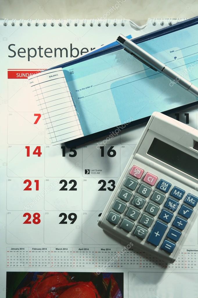 Calendar, checkbook, calculator, money and a ballpen — Stock Photo