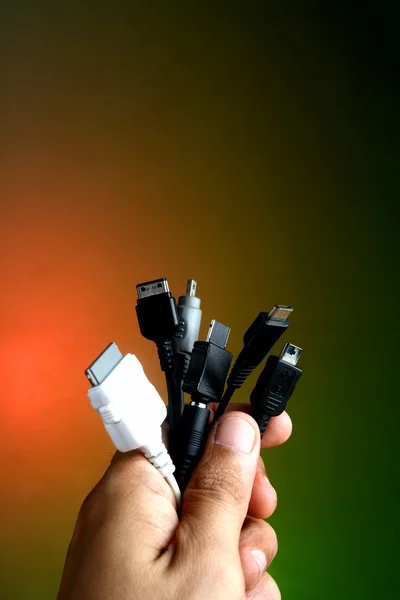 Hand holding different Gadget Chargers — Stock Photo, Image