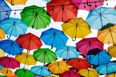 Photo of colorful umbrellas used as a decoration over a walkway