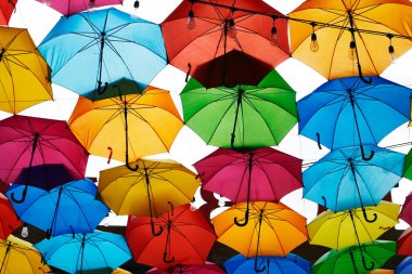 Photo of colorful umbrellas used as a decoration over a walkway