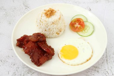 Photo of freshly cooked Filipino food called Tocilog or cured pork, egg and fried rice.