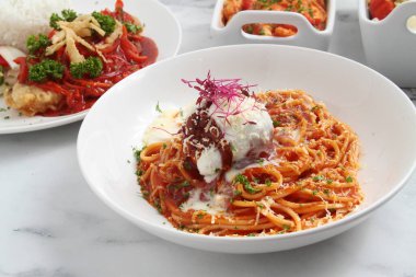 Photo of freshly cooked spaghetti pasta with meatballs.