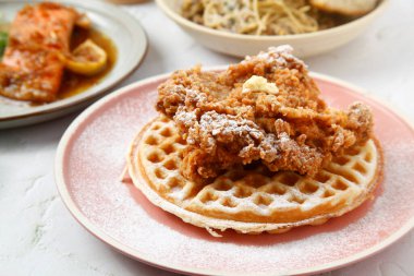 Photo of freshly cooked waffles and fried chicken fillet.