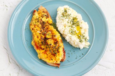 Photo of freshly prepared baked salmon served with mashed potato
