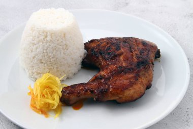Photo of freshly cooked grilled chicken served with steam rice.
