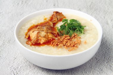 Photo of freshly cooked Filipino food called goto or lugaw or rice porridge topped with an assortment of choice meat