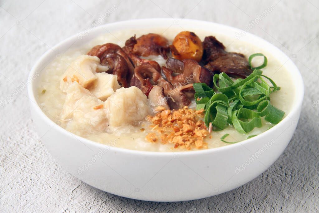 Photo of freshly cooked Filipino food called goto or lugaw or rice porridge topped with an assortment of choice meat