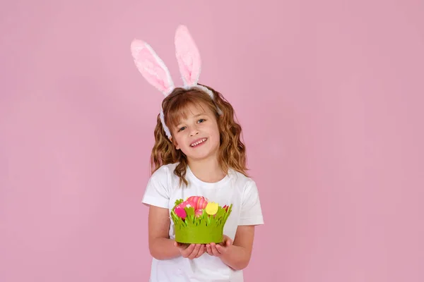 Flicka i påsk kanin öron pannband håller i händer Påsk ägg — Stockfoto