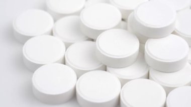 Many white medical pills rotating close up. Pharmaceutical Industry and medicine concept. 
