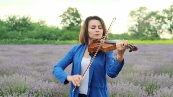 Adult Woman Blue Dress Playing Violin Lavender Field Summer Day — стоковое видео