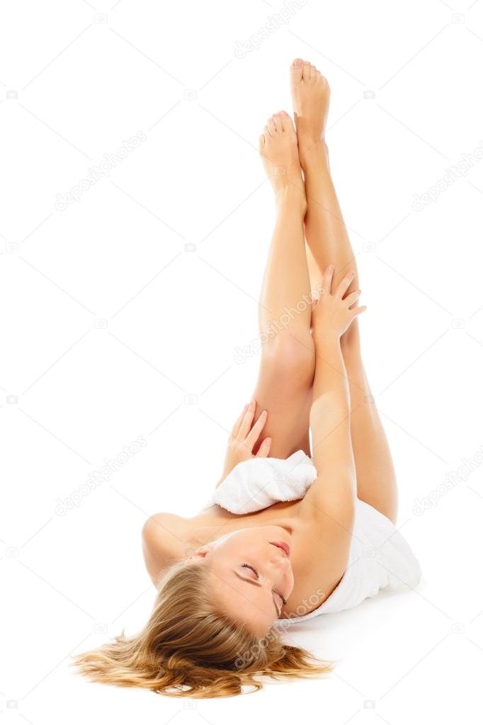 young woman in towel terry feet up lies on floor