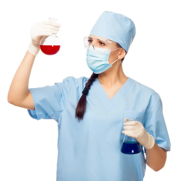 Woman chemist with colored flasks in their hands — Stock Photo, Image