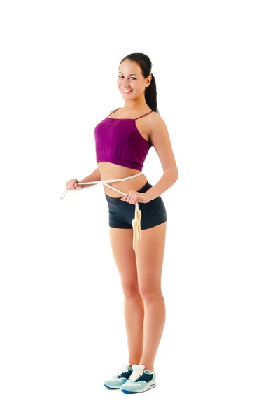 Young woman with  jump rope round  waist stand sideways in sport — Stock Photo, Image