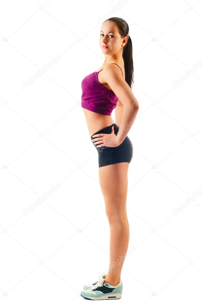 Young woman in sportswear stands sideways - Stock Photo, Image. 