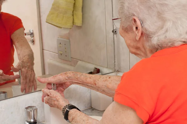 Elderly Lady Washing Her Hands Liquid Soap Bathroom Stock Photo