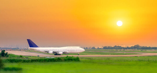 Ho Chi Minh City, Vietnam - May 22nd, 2021: Cargo plane landing at Tan Son Nhat International Airport with sunset sky background, Ho Chi Minh City, Vietnam