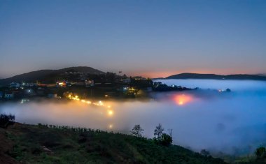 Gece manzarası, sisli bir kasabada, renkli evler ve ışıklar altında, Vietnam 'ın Da Lat dağlarında geceyi güzelleştiriyor.