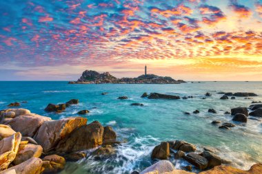 Landscape of the small island with the ancient lighthouse at sunset sky is beautiful and peaceful. This is the only ancient lighthouse is located on the island in Vietnam clipart
