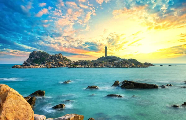 Landscape of the small island with the ancient lighthouse at sunset sky is beautiful and peaceful. This is the only ancient lighthouse is located on the island in Vietnam
