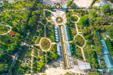 Aerial view of Da Lat city beautiful tourism destination in central highlands Vietnam. Urban development texture, green parks and city lake.