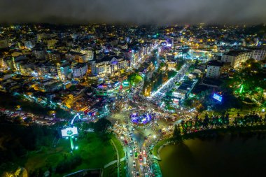 Aerial view of Da Lat city night beautiful tourism destination in central highlands Vietnam. Urban development texture, green parks and city lake.