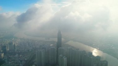 Ho Chi Minh city, Vietnam - June 4th, 2022: Aerial view morning of skyscrapers hidden in the clouds in the center of heart business at downtown in Ho Chi Minh City, Vietnam