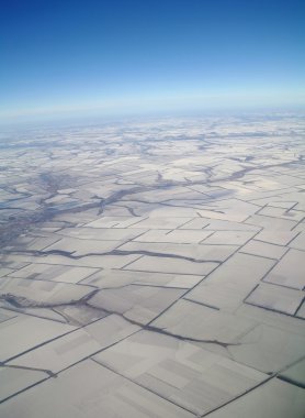 View of Earth from a height covered with snow during the winter season clipart