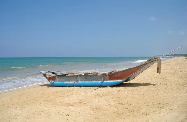 Bateau de pêcheur exotique sur la plage près de l'océan — Photo