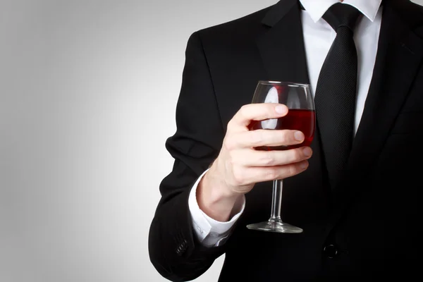 Young man holding a glass of red wine — Stock Photo, Image
