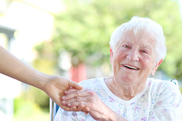Senior Woman Holding Hands with Caretaker