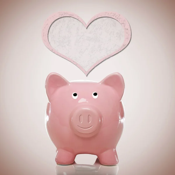 Piggy bank with pink heart — Stock Photo, Image