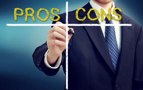 Business man writing pros and cons — Stock Image Business man writing pros and cons Stock Picture