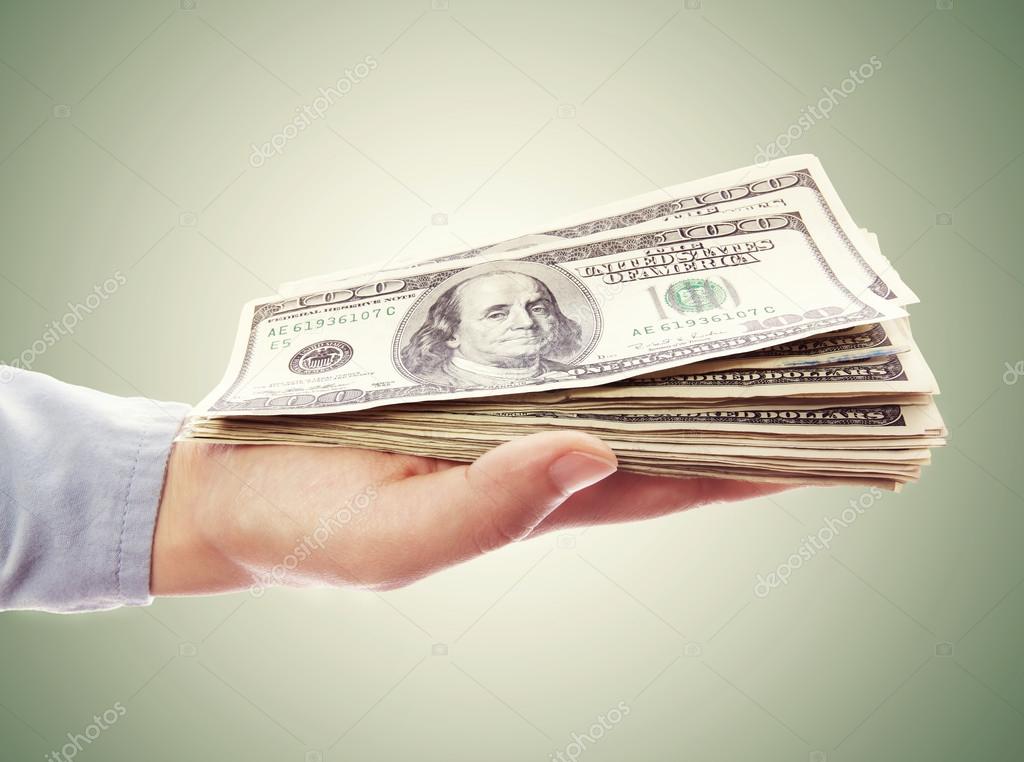Hand Holding Pile of Cash