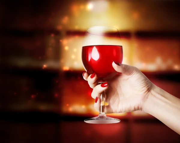 Wine glass being held in a womans hand — Stock Photo, Image