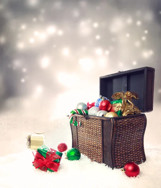 Treasure box filled with Christmas ornaments and presents — Stock Photo, Image