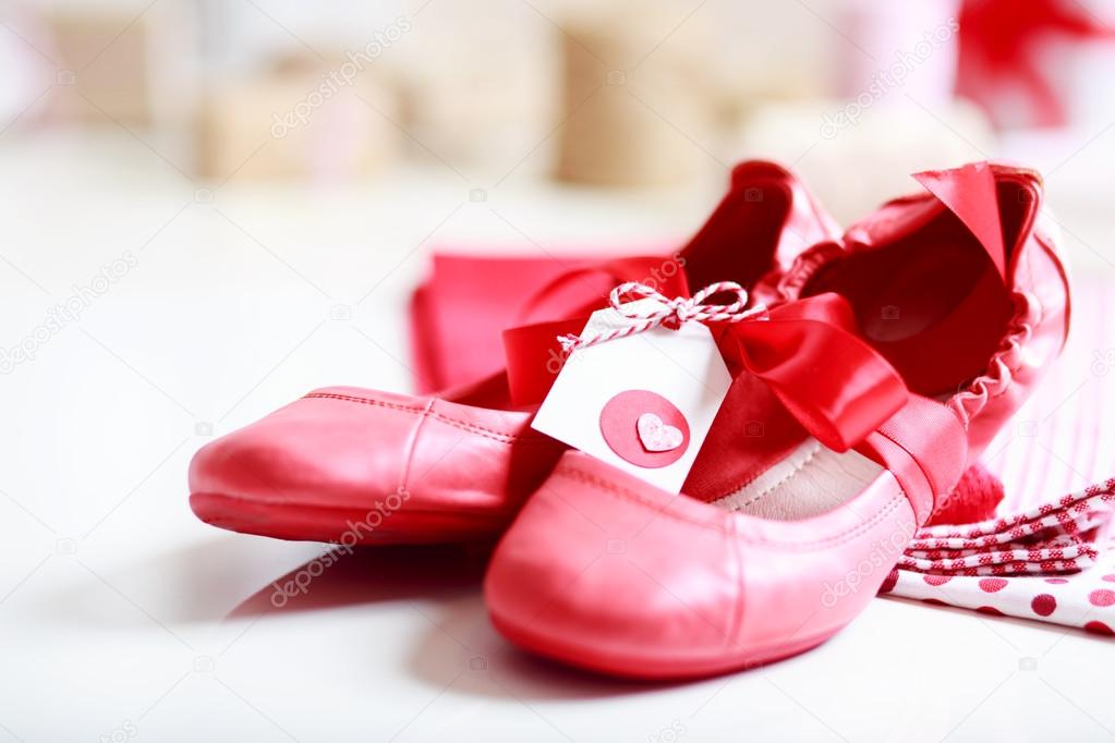 Red shoes with ribbon and heart tag
