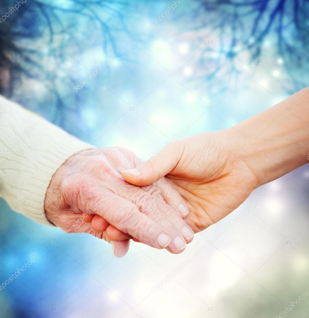 Holding hands with elderly woman